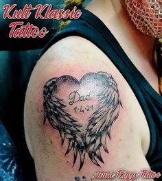 a heart with wings and the words dad is love written in black ink on a woman's shoulder