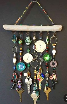 a surfboard hanging on the wall with lots of keychains and charms attached to it