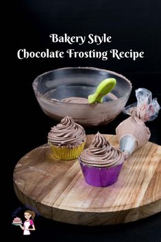 cupcakes with chocolate frosting sitting on a cutting board next to a bowl