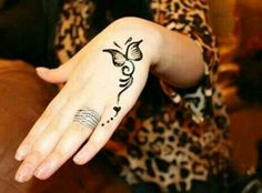 a woman's hand with a tattoo on it