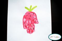 a child's handprinted picture of a pink radish on white paper