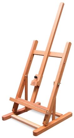 a wooden easel sitting on top of a white surface