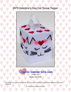 a cross stitch tissue box with a cat face on the front and side, in white