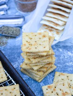 crackers are stacked on top of each other in front of some baking utensils