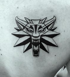 a black and white image of a wolf head on the back of a man's shoulder