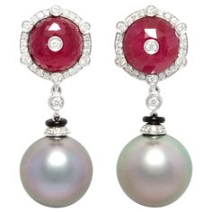 The Tahitian pearl diamond and ruby earrings feature two faceted decorative rubies accented with a diamond in the center and set in a crown of round diamonds. The total weight of diamonds of top quality (F/G-VVS) is 1.10 carats. The tops suspend a pair of marvelous Tahitian pearls of the rare size of 17mm. All of our pearls are untreated: their natural color and luster have not been enhanced in any way. The earrings are one-of-a-kind. The earrings were handmade in Italy in our own workshop in 18 Art Deco Drop Earrings, Diamond Bracelet Design, Pearl Jewels, Tahitian Black Pearls, Pearl And Diamond Earrings, Long Drop Earrings, Ruby Earrings, Tahitian Pearls, Women Diamond