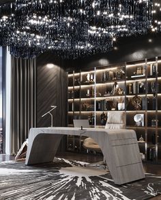 a room with a desk, bookcases and chandelier