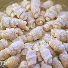 powdered sugar coated pastries in a glass bowl