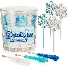 the frozen ice rock candy is next to two snowflakes and some lollipop sticks