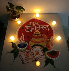 a decorated diya with lit candles around it