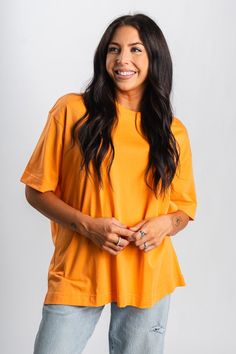 Oversized t-shirt from Lush Fashion Lounge women's boutique in Oklahoma City. Lush boutique in OKC has a variety of cute tops and more! This cute oversized tee is perfect for back to school! Pair with biker shorts or denim shorts for an easy to wear look! Model is 5'7 size 27 wearing size small. 100% cotton Oversized Orange Casual T-shirt, Oversized Orange Graphic Print T-shirt, Orange Relaxed Fit T-shirt For Everyday, Orange Relaxed Fit T-shirt For Beach, Orange Relaxed Fit Short Sleeve T-shirt, Women's Boutique, Under Dress, Capri Blue, Mom Tees