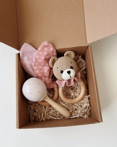 a teddy bear in a box with toys