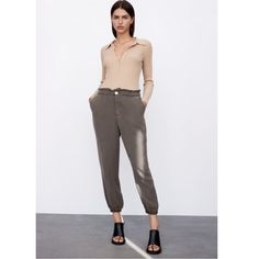 Flowy Baggy Pants High-Waisted Pants With Elastic Waistband. Front Pockets. Elastic Cuffs. Front Zip And Button Closure. Color: Dark Khaki Size: Large Khaki Bottoms With Elastic Waistband For Fall, Khaki Harem Pants With Elastic Waistband For Fall, Fall Khaki Harem Pants With Elastic Waistband, Trendy Summer Sweatpants With Tapered Leg, Chic Baggy Ankle-length Cargo Pants, Casual Summer Pants With Button Cuffs, Relaxed Fit Bottoms With Button Cuffs For Loungewear, Trendy Khaki Ankle-length Pants, Casual Ankle-length Pants With Button Cuffs