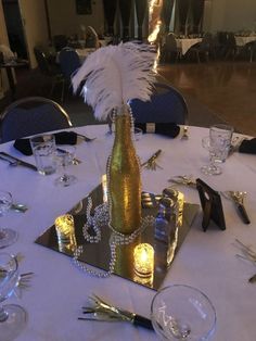 a table set up for a party with silverware and wine glasses on it,