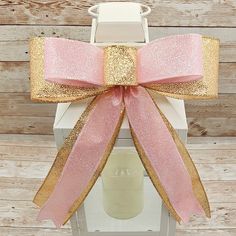 *This is a handmade bow made with wired glittered gold ribbon and pink ribbon. *This listing is for the BOW ONLY. Lantern and candle are not included. Display lantern is approximately 14 inches tall for size reference.* *This bow would be a great addition to a wreath, garland, swag, lantern, basket, gift wrapping or pary decor. *Bow measures approximately 8 inches wide and 12 inches from top to bottom. Gold Party Bow, Gold Ribbon Bow For Gifts, Gold Satin Bow For Gift, Gold Party Bow With Ribbon, Gold Ribbon Bow For Party, Gold Decorative Bow For Party, Gold Satin Bow For Wedding, Basket Gift Wrapping, Bow Party