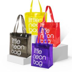 three different colored bags with the words little neon bag on them