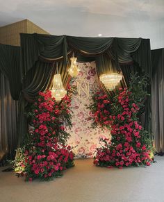 the stage is decorated with roses and chandeliers for a wedding or special event