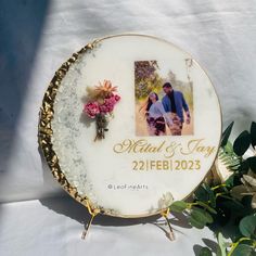 a white plate with a photo and flowers on it