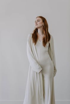 "This luxe, full length lightweight cardigan is made from a finely ribbed fabric with a super soft hand feel. It has a relaxed fit, drop shoulders and slouchy sleeves for a slightly oversized look. Made from 90% plant based, environmentally responsible TENCEL, it's light as air while providing the perfect amount of coverage. The 10% Spandex fabrication also adds a bounce and stretch for exceptional comfort. Like all of our pieces, this cardigan is exclusively handmade to order by us in limited q Long Sleeve Relaxed Fit Robe For Fall, Long Sleeve Cardigan For Lounging In Fall, Cream Long Sleeve Cardigan For Loungewear, Beige Long Sleeve Cardigan For Loungewear, Fitted Long Sleeve Cardigan For Loungewear, Fitted Open Front Robe For Loungewear, Fitted Spring Robe For Loungewear, Fitted Robe For Spring Loungewear, Fitted Long Sleeve Robe For Loungewear