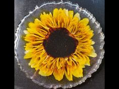 a glass plate with a sunflower on it