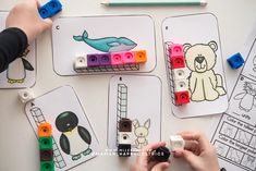 children are playing with legos to make their own animal pictures on the paper sheet