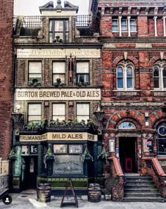 an old brick building with many windows and signs on it