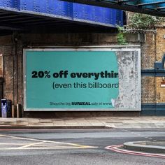 an advertisement on the side of a building advertising 20 % off everything even this billboard