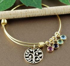 Take a LOOK at our Website: ANNIEREH.com Gold Family Tree Bracelet with Birthstones, Grandmother Bracelet, Tree of life Charm Bracelet, Mom Bracelet, Grandma Bracelet, Gift for Mom GOLD Tree Family Bangle Bracelet for Mom or Grandma with birthstones to represent each child or grandchild CAN BE DESIGNED IN SILVER - Select Color Bangle at check out Details for Bracelet: * Stainless Steel Gold Bangle * ONE Gold Bronze Family Tree Pendant * ONE Birthstones - Select more at check out - price will adj Spiritual Jewelry For Friendship And Mother's Day, Adjustable Spiritual Bracelets As Gifts For Mom, Mother's Day Gift Bangle Jewelry For Mom, Mother's Day Gift Bangle Jewelry, Mother's Day Bangle Gift For Mom, Adjustable Bangle Jewelry Gift For Mom, Stackable Round Friendship Jewelry, Stackable Round Jewelry For Friendship, Friendship Birthstone Bracelet