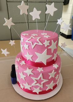 a pink and white cake with stars on it