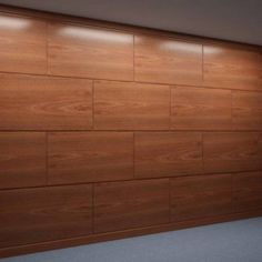 an empty room with wood paneling on the wall