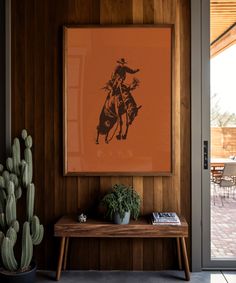 an image of a cowboy on a horse mounted to the wall