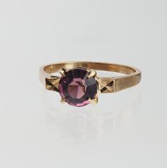 Vintage 1940s 10k gold purple stone ring. The ring is a size 5.5 and can be sized. Vintage Purple Sapphire Gemstone Ring, Antique 14k Gold Purple Ring, Vintage Purple Amethyst Ring Stamped 14k, Vintage Purple Promise Ring, Vintage 14k Gold Purple Jewelry, Vintage 14k Gold Amethyst Promise Ring, Vintage Amethyst Ring With Center Stone For Promise, Vintage Purple 14k Gold Jewelry, Vintage Purple Solitaire Ring