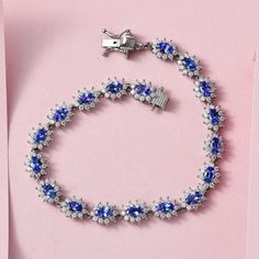 This exquisite floral bracelet is the epitome of elegance and beauty. Crafted from sterling silver, it features genuine gemstones in a stunning Halo design that is sure to turn heads. The intricate detailing of each gemstone adds a touch of sophistication and luxury to any outfit. Whether you're dressing up for a special occasion or simply want to add a touch of glamour to your everyday look, this bracelet is the perfect choice. Item Details- Metal- Sterling Silver Stone- Tanzanite Shape- Oval 5x3mm Total Weight- 12.50 Ct. Approx Accent Stone- Moissanite Shape- Round 1.5mm Setting- Prong Finish- Platinum Overlay Clasp- Box Halo Bracelet, Tanzanite Bracelet, Tanzanite Jewelry, Cluster Bracelets, Floral Bracelet, Tanzanite Gemstone, Wedding Jewelry Bracelets, Bracelet Gemstone, Birthstone Bracelets