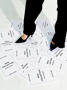 a woman standing on top of a pile of white papers