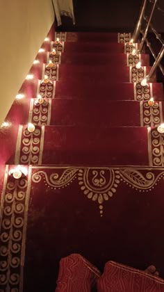 red carpeted stairs with lit candles on them