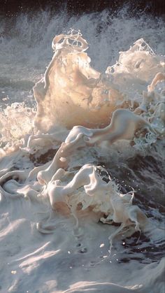 an ocean wave with white foam on it