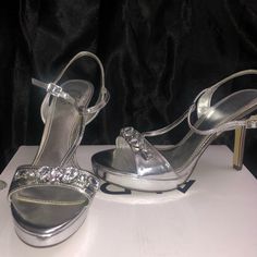 Never Worn Before Silver Shiny Heels For Formal Occasions, Elegant Shiny Silver Heels, Formal Silver Shiny Heels, Silver Open Toe Heels For Night Out, Silver Open Toe Heels For Formal Occasions, Silver Shiny Heels For Spring, Metallic Silver Heels For Spring, Silver Heels With Round Toe In Synthetic Material, Silver Synthetic Heels With Round Toe