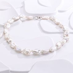 Enhance your style with our Flat Baroque Pearl Necklace, featuring 12-15mm pearls with top-grade AAAA luster. Each unique, flat-shaped pearl is complemented by a romantic heart-shaped silver clasp, blending elegance with a personal touch. Product Details: Pearl Type: Flat Baroque Pearls Pearl Size: 12-15mm Quality: AAAA Luster Shape: Flat Material: Silver with Heart Clasp Style: Elegant and Unique Occasion: Perfect for special events or adding sophistication to everyday wear. This necklace combi Baroque Pearls Necklace, Modern Heart, Romantic Heart, Baroque Pearl Necklace, Wear Necklaces, Pearl Necklaces, White Necklace, Necklaces Jewelry, Pearl Types