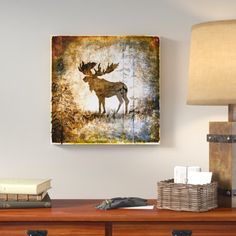 a painting on the wall above a desk with a lamp and other items in front of it