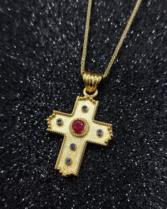 Βyzantine Handmade Gold Cross with Natural Ruby and Sapphire. An exquisite handmade Byzantine cross in 14 yellow gold and set with a central ruby of 0.29 carats and diameter 3,70mm and 5 sapphires diameter 1.35mm ideal choice for a baptismal cross but also as a special and unique piece of jewelry that you can wear every day. Details: Height32 mm Width:20 mm Weight:5.20gr Metal:14k Yellow Gold  Style:      Baptism Cross ❣️ For more  crosses take a look here      👉  https://www.etsy.com/shop/Gior Necklace With Red Stone, Three Earrings, Byzantine Cross, Byzantine Jewelry, Three Necklaces, Cross Gold, Ruby And Sapphire, Historical Jewellery, Two Rings