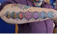 a woman with a tattoo on her arm that has phases of the moon in it