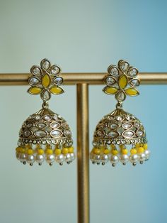 Meet our Sunflower Jhumka: a unique South Asian jewelry piece meticulously handcrafted to reflect the intricate petals and golden hues of a sunflower in full bloom. Featuring radiant yellow and light blue gemstones and lustrous pearls, this small jhumka earring is a stylish flower earring hand-fitted with dazzling gemstones. Designed as a traditional antique gold plated polki jhumka with a twist, this sunflower earring adds a touch of sunshine to everyday gold jewelry. Materials: Mehndi gold pla Small Jhumka, Everyday Gold Jewelry, Sunflower Earring, South Asian Jewelry, Everyday Jewelry Gold, Light Blue Gemstone, Jewelry Materials, Asian Jewelry, Flower Earring