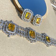 Fancy Yellow Sapphire Canary Diamond Choker Necklace is a masterpiece inspired by the timeless elegance of Harry Winston Jewellery. Adorned with resplendent Fancy Yellow Diamonds, a gracefully designed Yellow Sapphire Necklace, and a Yellow Choker embellished with the brilliance of American Diamonds, it encapsulates the opulence of Indian jewelry craftsmanship in every intricate detail. This exquisite piece is meticulously crafted, making it the perfect complement to enhance the allure of your Bridal Wedding ensemble. *𝐏𝐑𝐎𝐃𝐔𝐂𝐓 𝐃𝐄𝐓𝐀𝐈𝐋* * Material: Brass * Plating: White Rhodium Plated * Stone: AAA-quality CZ yellow diamond & canary diamond. *𝐃𝐈𝐌𝐄𝐍𝐒𝐈𝐎𝐍𝐒*  Necklace * Weight: 61 gm * Design Length: 8  inches * Total Length with Closure: 15.75 inches * Width: 1.7 Inches Elegant Topaz Jewelry For Wedding, Elegant Wedding Jewelry With Topaz, Elegant Topaz Wedding Jewelry, Elegant Yellow Bridal Necklace For Party, Luxury Wedding Jewelry Sets With Gemstones, Luxury Citrine Necklace For Wedding, Luxury Yellow Jewelry For Wedding, Elegant Yellow Jewelry Sets For Formal Occasions, Luxury Yellow Wedding Jewelry