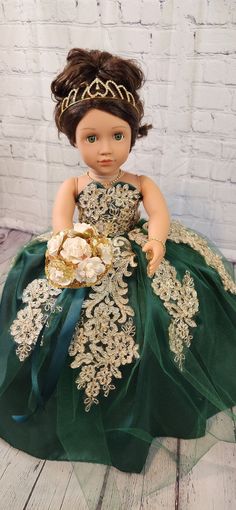 the doll is wearing a green and gold dress