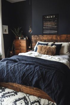 a bedroom with black walls and white rugs on the floor, wooden bed frame