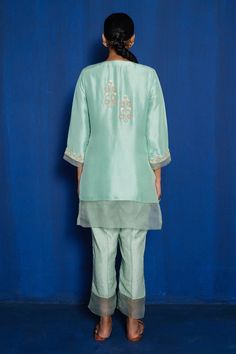 Mint green kurta with hand embroidery of zardozi with thread, cutdana and moti. Comes with pajama.
Component: 2
Pattern: Hand Embroidered
Type Of Work: Zardozi, Cutdana, Thread, Moti
Neckline: V-Neck
Sleeve Type: Three Quarter
Fabric: Silk Dupion, Organza, Noki Silk
Color: Green
Other Details: 
Sheer hem panels
Floral motifs
Occasion: Mehendi and Haldi - Aza Fashions Green Tissue Silk Sets With Floral Embroidery, Green Floral Embroidered Tissue Silk Sets, Green Floral Embroidery Tissue Silk Sets, Green Embroidered Fabric With Dori Work, Pista Green Cotton Silk Sets With Floral Embroidery, Pista Green Embroidered Fabric With Dori Work, Green Silk Sets With Intricate Embroidery, Pista Green Straight Kurta Sets For Reception, Green Unstitched Suit With Floral Embroidery In Traditional Drape