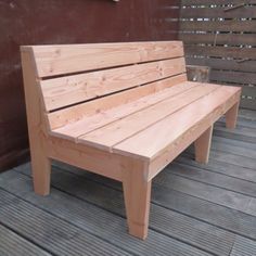 a wooden bench sitting on top of a wooden deck