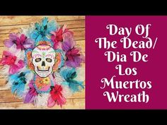 a paper mask with flowers and feathers on it, next to the words day of the dead dia de los muertos wreath