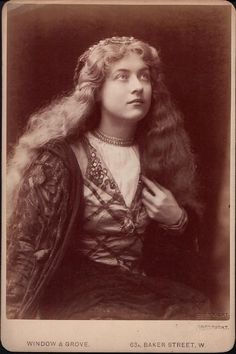 an old photo of a woman with long hair