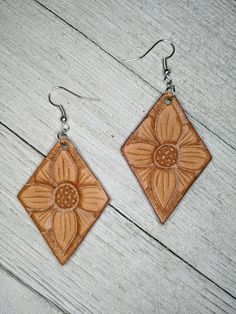 Earrings are lightweight and hand tooled from scratch. Finished product may vary slightly from the picture due to its handmade nature. Earrings are finished with silver earring hooks for easy wearing. Brown Flower Earrings With Ear Wire, Brown Dangle Flower Earrings For Pierced Ears, Beige Leather Jewelry, Everyday Brown Faux Leather Jewelry, Brown Flower Drop Earrings, Brown Flower Earrings, Hand Tooled Brown Earrings For Everyday Wear, Sunflower Leather Earrings, Brown Hand Tooled Dangle Earrings